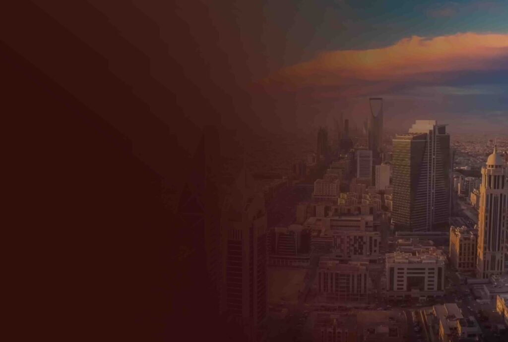 A Saudi city skyline at sunset with residential and office towers